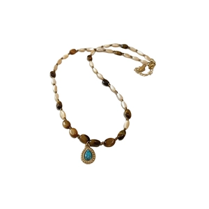 Bohemian beaded necklace with tiger eye stones and a turquoise teardrop pendant