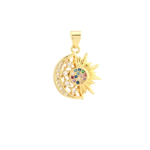 Macro view of gold sun and moon pendant with shimmering cubic zirconia inlay detailing