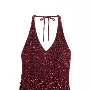 Elegant wine red sequin halter top with a deep V-neckline and shimmering fabric texture