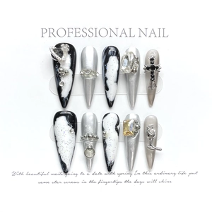 Silver metallic press-on nails with gothic cross, gems and marble patterns in stiletto shape