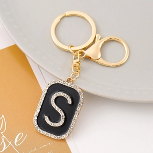 Detailed view of golden S-letter keychain with inlaid rhinestones and lobster clasp
