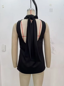 Detailed back view of a black halter top with elegant long tie-back straps
