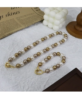 Detailed set of multi-colored pearl necklace and bracelet with gold round metal clasps