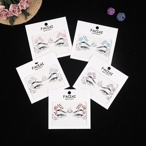 Flat lay of five assorted acrylic rhinestone face stickers in pink, blue, and purple hues