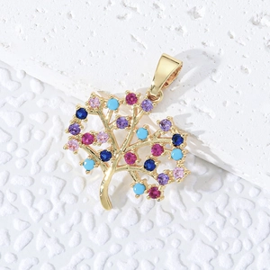 Golden tree of life pendant with colorful zircons on a textured white background