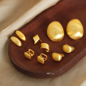 Elegant gold geometric earrings set with matte finish and rhinestones on silk