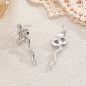 Macro detail of vintage silver snake earrings showing carved texture and secure butterfly backs