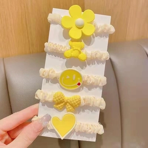 Set of 5 minimalist yellow hair ties with cute flower, bear, and heart charms