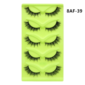 Detail view of 5 pairs of dense fox-eye faux mink eyelashes on a green holder
