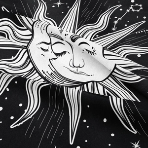 Close-up of bohemian fabric texture showing sun and moon mysticism pattern print