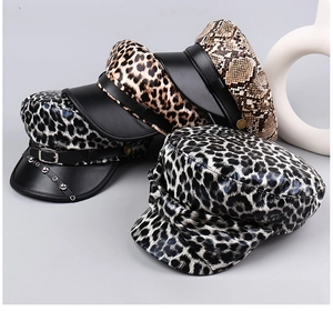 Close-up of leopard print flat top hats with PU leather brims and rivet detailing