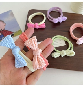 Colorful elastic bow hair ties made of soft fabric shown in various vibrant shades