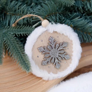 Round wooden Christmas ornament with white faux fur trim and silver sequin snowflake