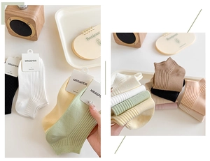 Detail showing various candy-colored ribbed cotton ankle socks in a lifestyle setting