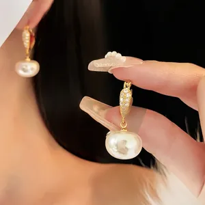 Elegant gold plated geometric earrings with pavé diamonds and lustrous white pearls