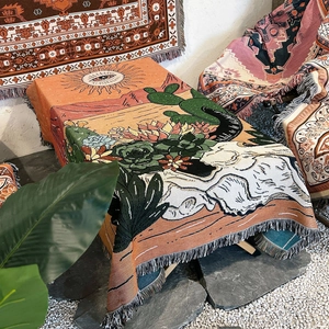 Detail of bohemian camping blanket showing desert cactus patterns and thick woven texture