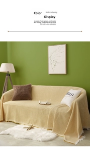 Close-up of beige waffle weave texture and tassel edge on cotton sofa cover