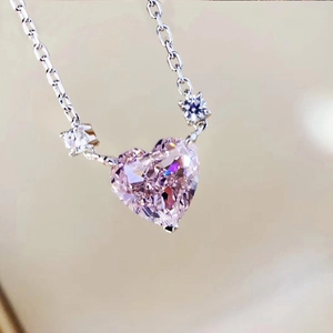 Sparkling pink heart-shaped crystal pendant necklace with silver chain and small side gems