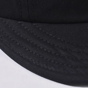 Detailed close-up of durable twill cotton fabric and neat parallel stitching on cap brim