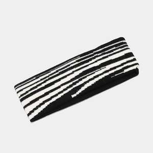 Detailed view of the thick elastic knitted headband with classic black and white stripes