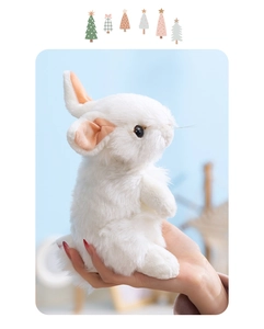 Close-up of a white plush rabbit with soft fur and pink ears held in hand for detail