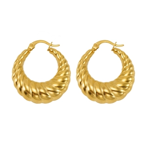 Detailed close-up of golden stainless steel croissant hoop earrings with polished twisted texture