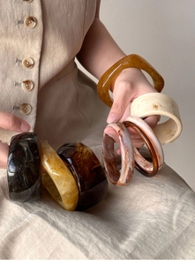Close-up of thick irregular resin bangles with tortoiseshell and marble texture