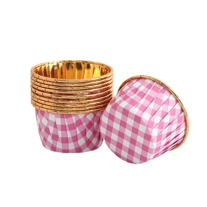 Pink checkered cupcake liners with gold rolled edges and aluminum foil lining for baking