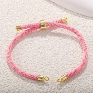 Pink Milan cord bracelet with adjustable gold plated slider bead and metal ends