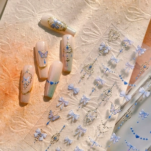 3D embossed blue butterfly nail stickers with gold accents and heart bow designs