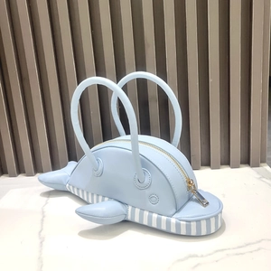 Detail of light blue dolphin-shaped PU leather handbag with nautical striped bottom