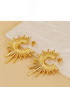 Detailed shot of irregular geometric C-shaped 18K gold plated sunburst stud earrings