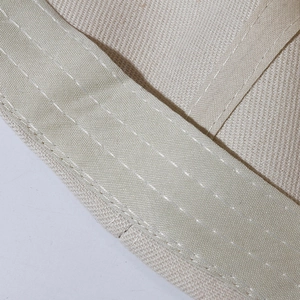 Close-up of cream white cotton baseball cap showing detailed parallel stitching craftsmanship