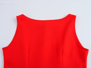 Detailed view of sleeveless red top with smooth fabric and elegant round neckline