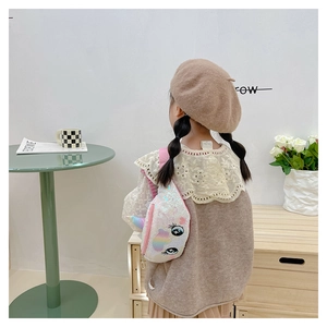 Rear view of a child wearing the unicorn sequin chest bag in a cozy home setting