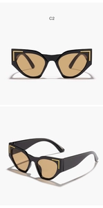 Detail view of cat eye sunglasses with glossy black frames and gold metal accents