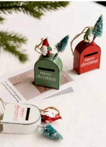 Close-up of festive Merry Christmas metal mailboxes with miniature trees and santa figures