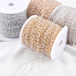 Golden and silver DIY jewelry chains with transparent crystal stones on white spools