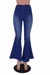 Detail view of high waist flared denim jeans with ripped knees and raw fringe hem