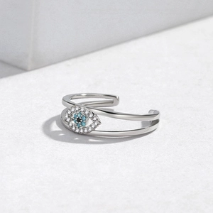 Macro view of evil eye open ring with silver finish and blue gemstone detail