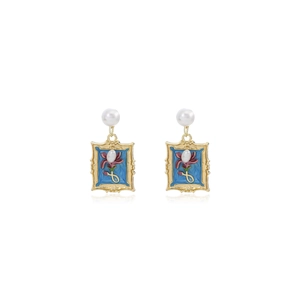 Detail view of Monet style floral earrings with blue enamel and pearl accents