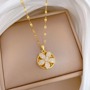 Elegant gold spinning flower pendant necklace with diamonds on champagne jewelry box