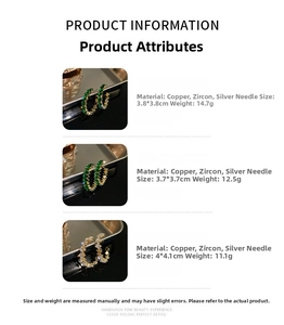 Detail showing green and white zircon C-shaped earrings with metal tray and sizing info