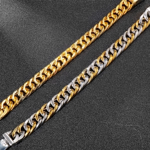 Macro view of heavy Cuban link chains in gold and silver on black leather texture