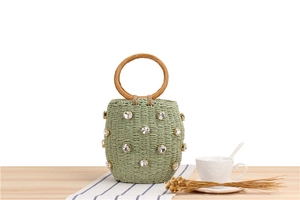 Sage green woven bucket bag with sparkling rhinestones and wooden round handles