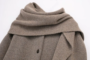 Close-up of dark brown knit cardigan with elegant scarf collar and resin button details