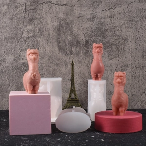 Detail view of pink alpaca resin figure next to a white silicone mold for DIY crafts
