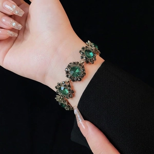 Vintage green crystal flower bracelet with black diamonds and gold chain on model