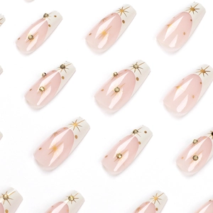 French tip press-on nails with nude pink base, gold starburst and bead accents