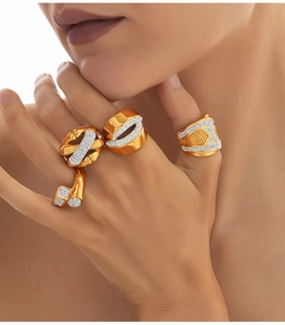 Detalle de anillos de titanio chapados en oro con micro-pavé de circonitas en la mano